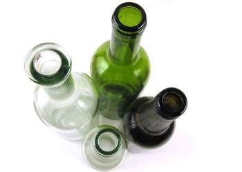 Four different glass bottles positioned on white background